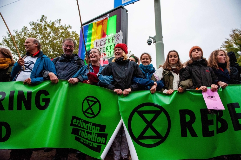 Protesters block a bridge to mark the beginning of the Extinction Rebellion protests in Amsterdam, on Monday. -Courtesy photo  