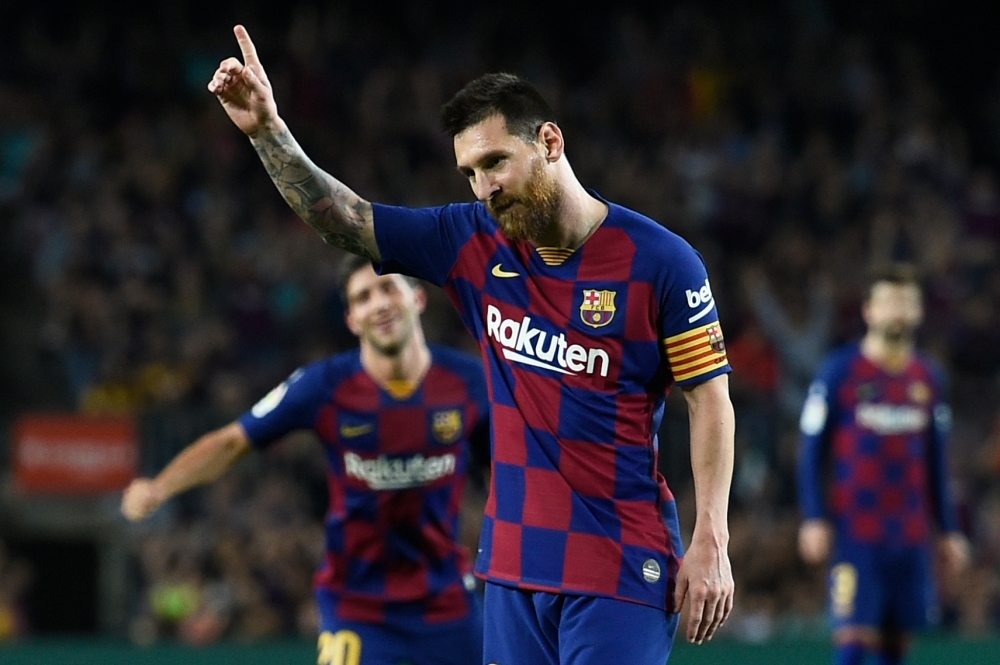 Barcelona's Argentine forward Lionel Messi celebrates his goal during the Spanish league football match between FC Barcelona and Sevilla FC at the Camp Nou stadium in Barcelona, on Sunday. — AFP