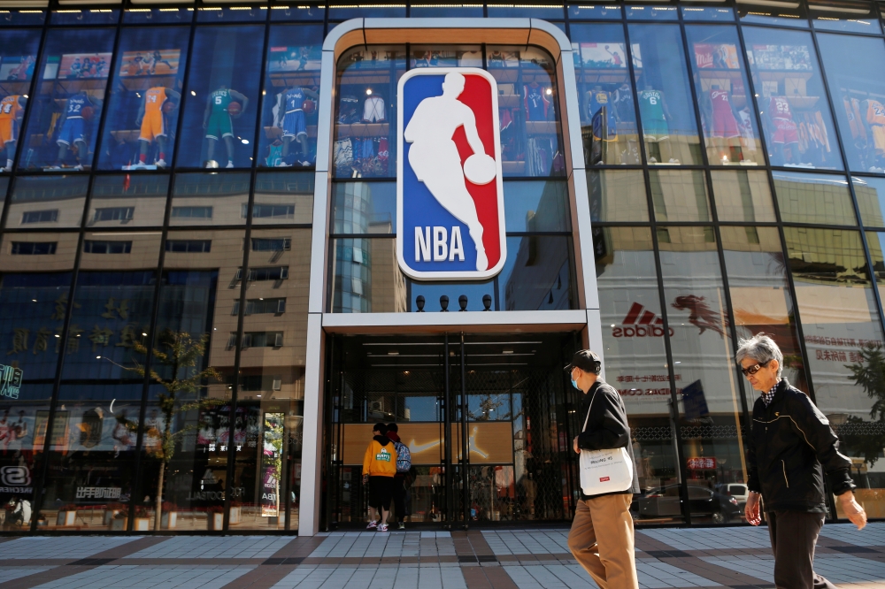 People enter a flagship NBA store at the Wangfujing shopping street in Beijing, on Tuesday. -Reuters