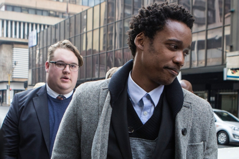 Duduzane Zuma, right, son of former South African president Jacob Zuma, leaves the court where he faced corruption charges before being released on bail in Johannesburg in this July 9, 2018 file photo. — AFP