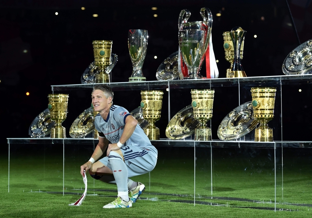In this file photo taken on Aug. 28, 2018, former Bayern Munich's midfielder Bastian Schweinsteiger poses in front his won trophys prior to the his farewell match between his former teams FC Bayern Munich and Chicago Fire in the stadium in Munich, southern Germany. Bastian Schweinsteiger, 2014 world champion with Germany and then captain of the Mannschaft, announced on Tuesday his international retirement on a social network. — AFP