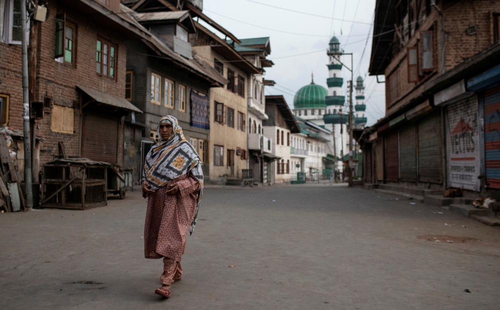 A Kashmiri woman walks through an empty street in Anchar neighborhood, during restrictions following the scrapping of the special constitutional status for Kashmir by the Indian government, in Srinagar, in this Sept. 20, 2019 file photo. — Reuters