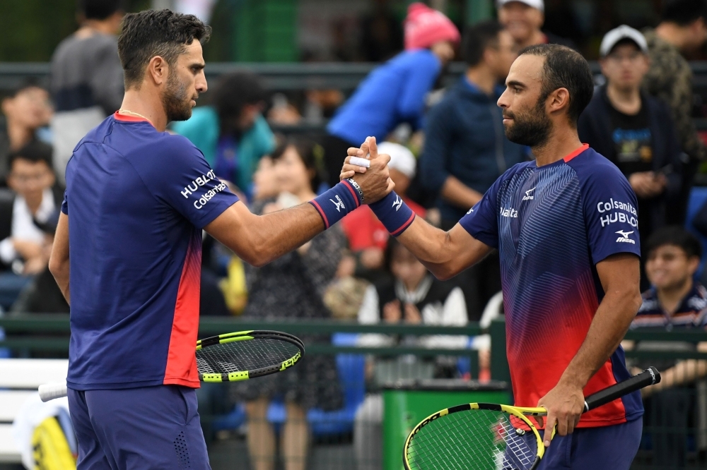 This photo taken on Wednesday shows Colombian tennis players, Juan Sebastian Cabal, right, and Robert Farah celebrating while playing John Isner and Sam Querrey of the US during the men's doubles second round match at the Shanghai Masters tennis tournament in Shanghai. — AFP