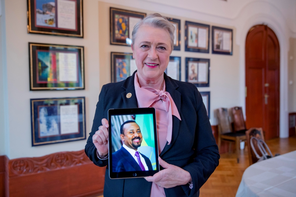 Chair of the Nobel Committee Berit Reiss-Andersen holds a picture of Ethiopia's Prime Minister Abiy Ahmed, whom she previously announced as the Nobel Peace Prize Laureate for 2019, displayed on a sceen in Oslo, Norway Friday. — Reuters