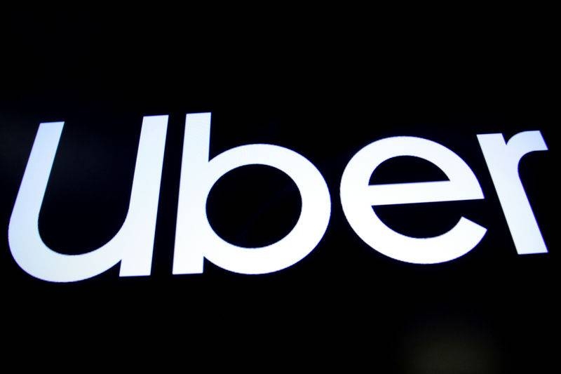 FILE PHOTO: A screen displays the company logo for Uber Technologies Inc. on the day of it's IPO at the New York Stock Exchange (NYSE) in New York, U.S., May 10, 2019. REUTERS/Brendan McDermid/File Photo