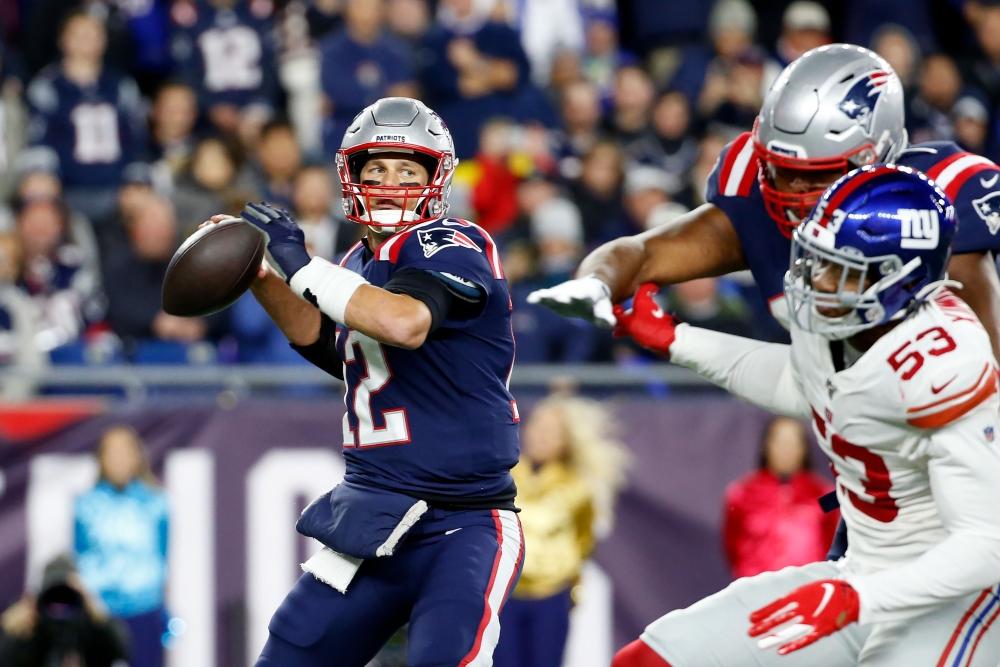 New England Patriots quarterback Tom Brady (12) looks to pass against the New York Giants during the first half at Gillette Stadium on Thursday.  — Reuters