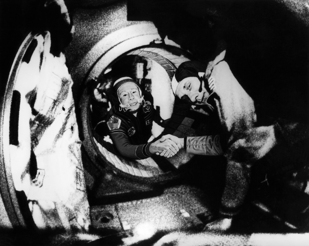 Commander of the Soviet crew of Soyuz, Alexei Leonov, left, and commander of the US crew of Apollo, Thomas Stafford, right, shake hands after the Apollo-Soyuz docking maneuvers. — AFP