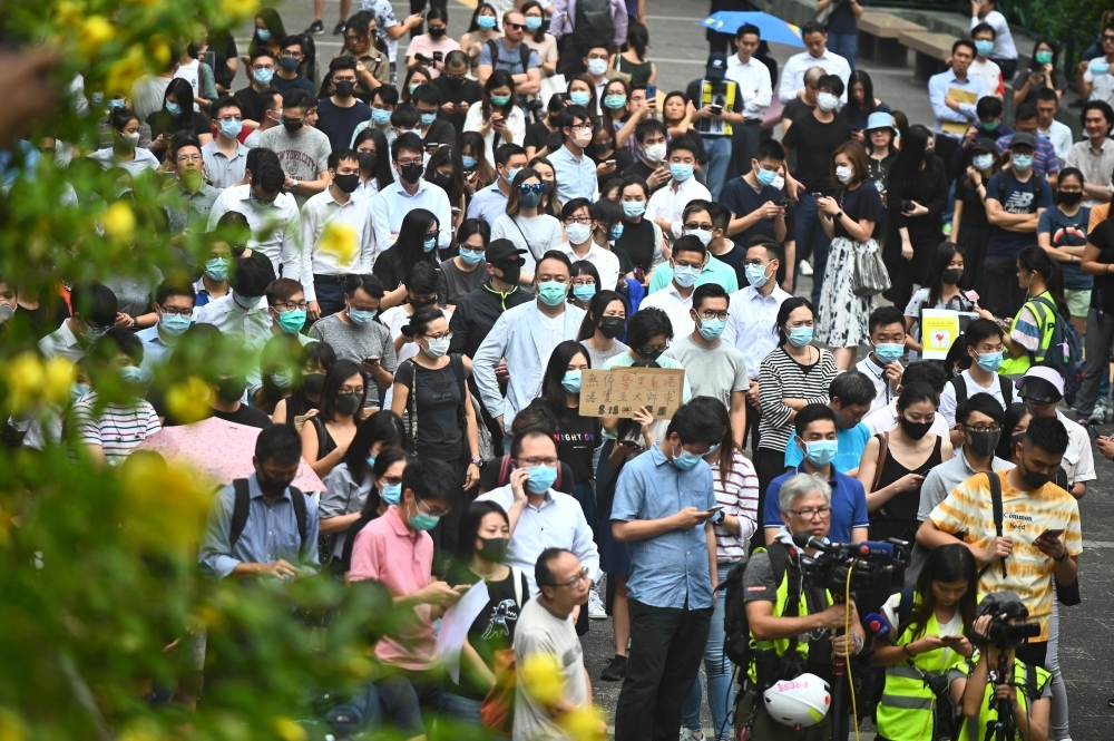 People attend a flash mob rally to show support for pro-democracy protesters in the Central district in Hong Kong on Friday. — AFP