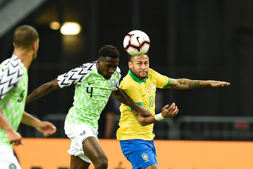 Brazil's forward Neymar (R) fight for the ball with Nigeria's midfielder Wilfred Ndidi during an international friendly football match between Brazil and Nigeria at the National Stadium in Singapore, on Sunday. — AFP