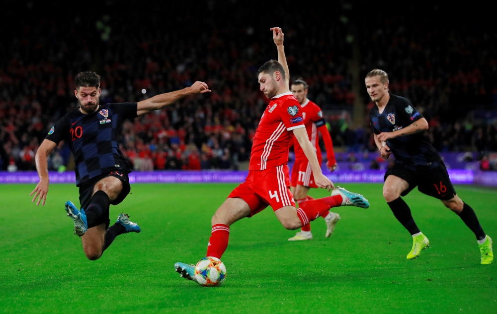 Wales' Ben Davies in action with Croatia's Bruno Petkovic during the Euro 2020 Qualifier Group E match at the Cardiff City Stadium, Cardiff, Britain, on Sunday. — Reuters