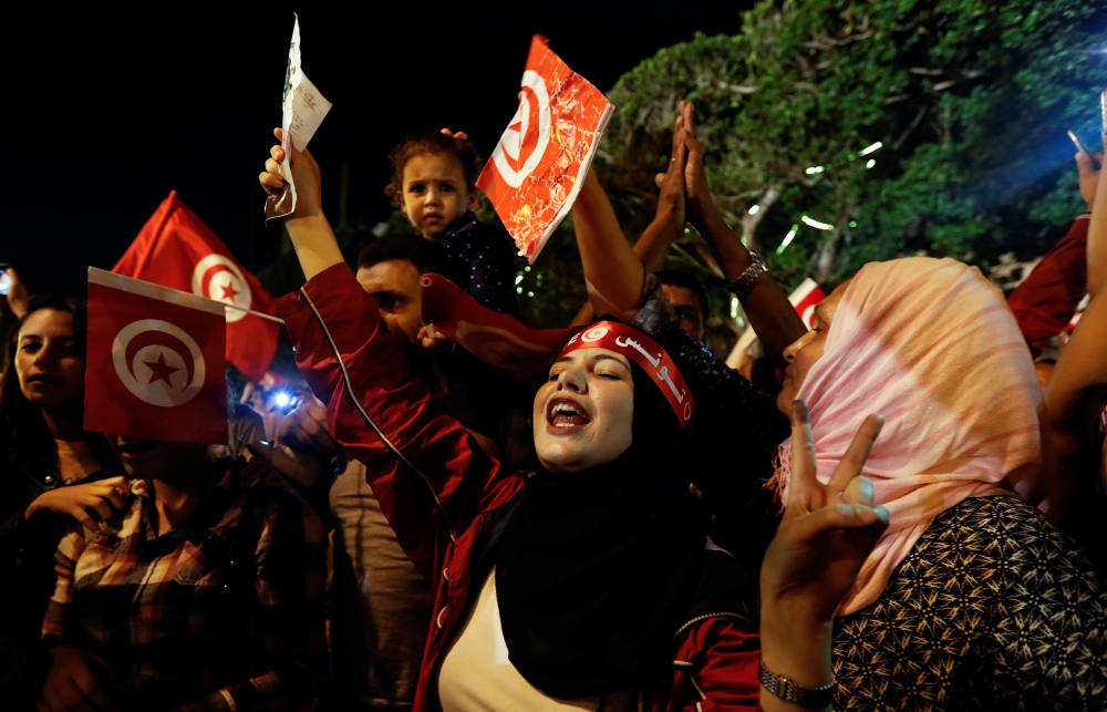 People react after exit poll results were announced in a second round runoff of the presidential election in Tunis, Tunisia, on Sunday. — Reuters