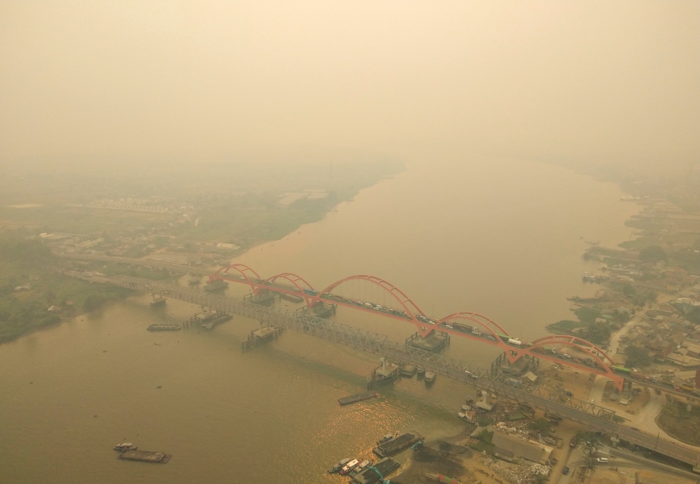 An aerial view of Palembang city covered by smoke from the forest fire in South Sumatra province, Indonesia, on Monday. -Reuters 