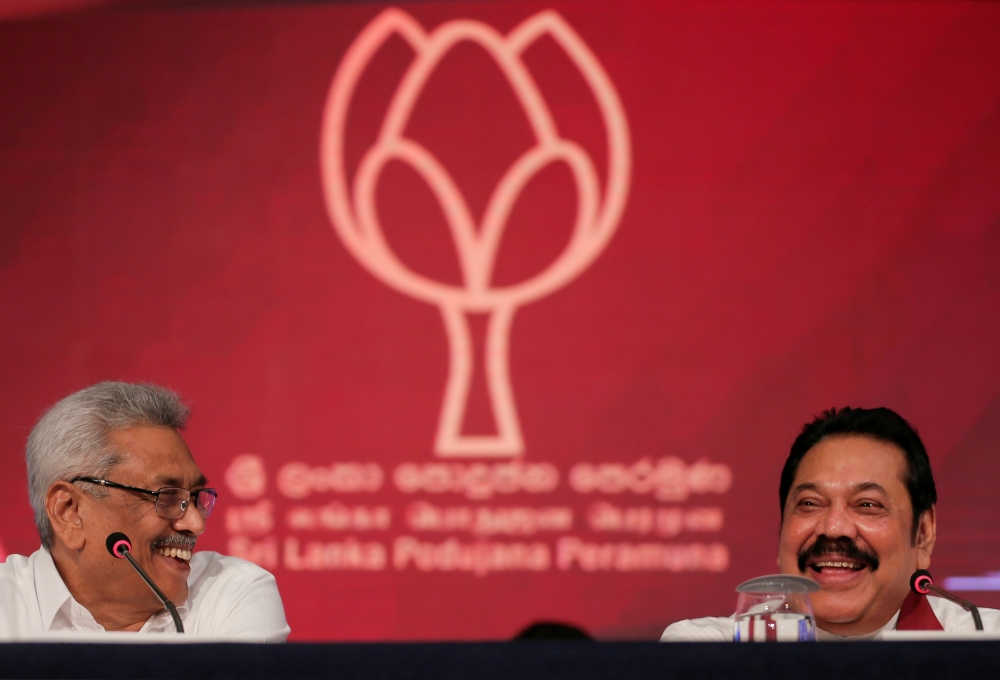 Gotabhaya Rajapaksa, left, Sri Lanka People's Front party presidential election candidate and former wartime defence chief and his brother and former president, Mahinda Rajapaksa attend a news conference in Colombo, Sri Lanka, on Tuesday. — Reuters