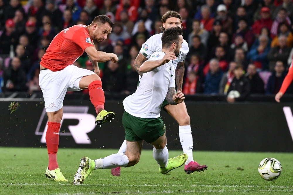 Switzerland's forward Haris Seferovic (L) scores his team's first goal during the Euro 2020 football qualification match between Switzerland and Ireland at the Stade de Geneve stadium in Geneva, on Wednesday — AFP