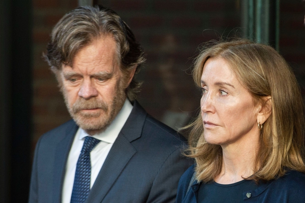 Actress Felicity Huffman, escorted by her husband actor William H. Macy, exits the John Joseph Moakley United States Courthouse in Boston, where she was sentenced by Judge Talwani for her role in the College Admissions scandal, in this Sept. 13, 2019 file photo. — AFP