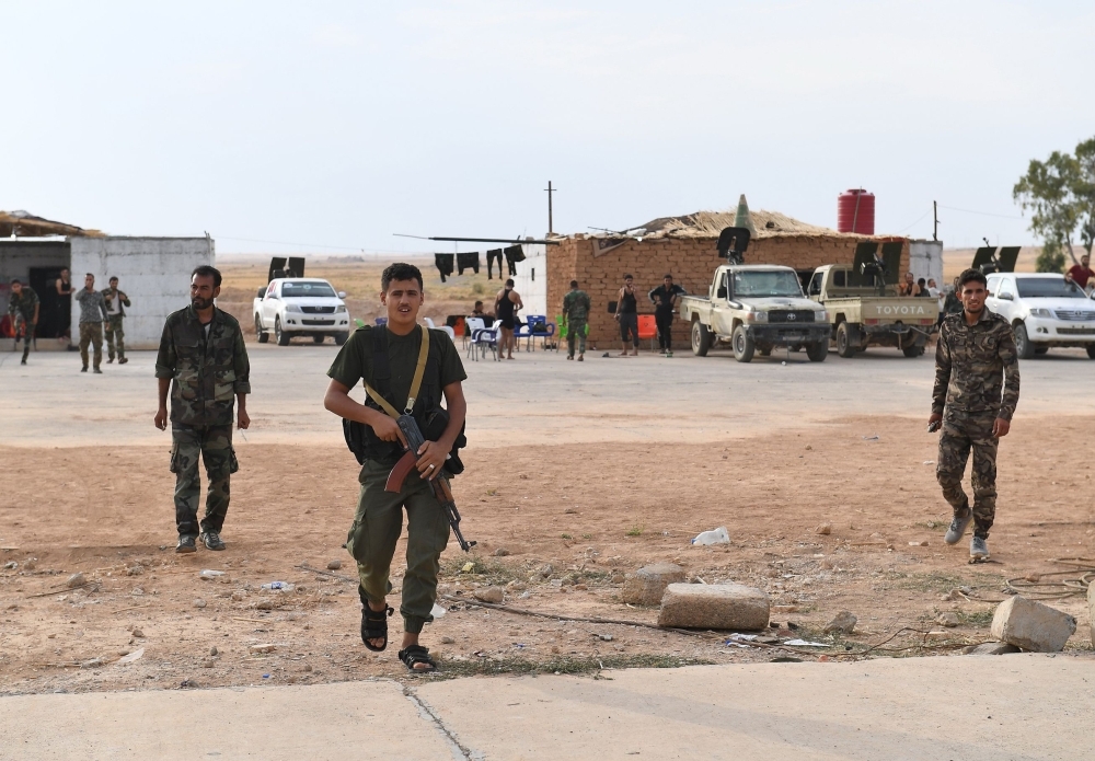 Syrian government forces gather at Tabqa air base in the northern Raqqa region on Wednesday. — AFP