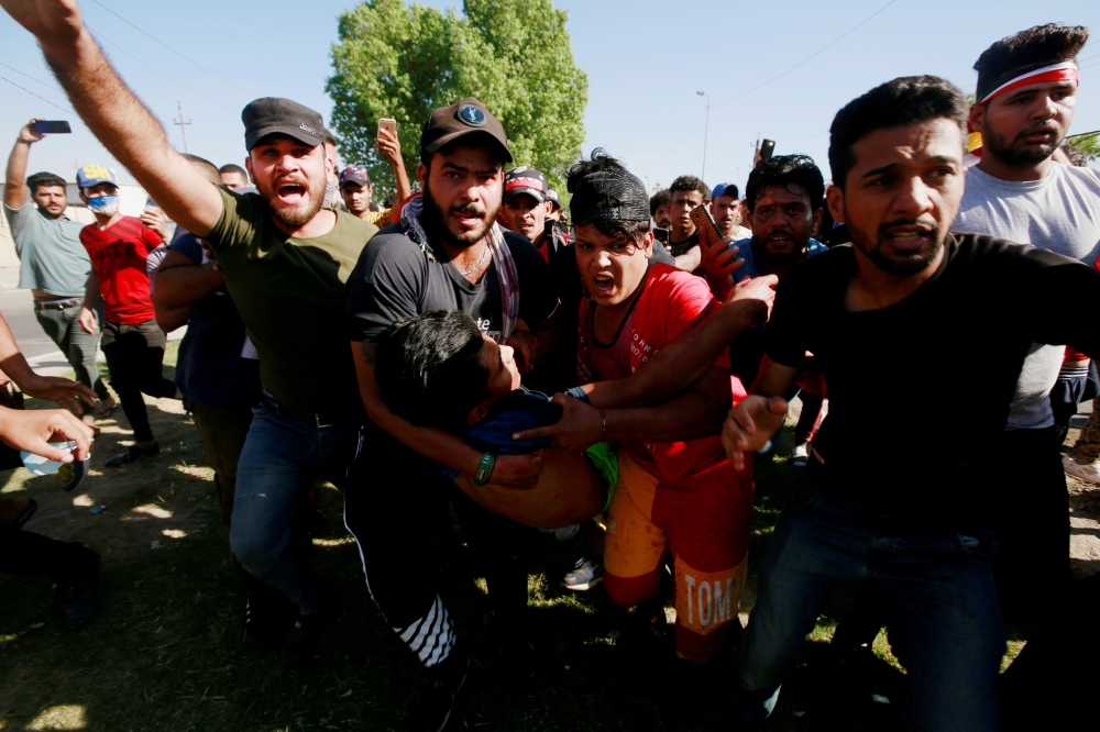 Men carry an injured demonstrator at a protest during a curfew, three days after the nationwide anti-government protests turned violent, in Baghdad, in this Oct. 4, 2019 file photo. — Reuters