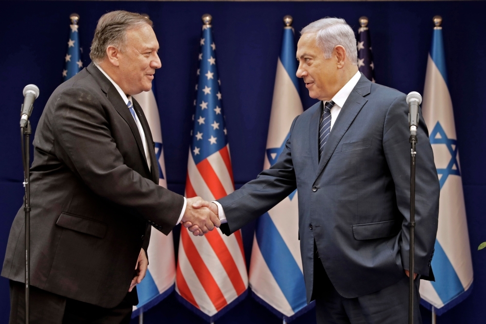 Israeli Prime Minister Benjamin Netanyahu, right, shakes the hand of US Secretary of State Mike Pompeo following their meeting in Jerusalem on Friday. — AFP