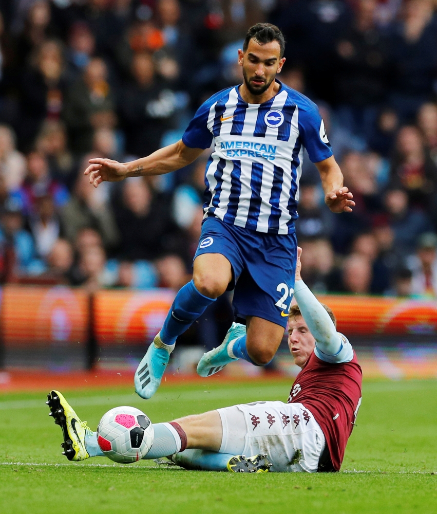 Brighton and Hove Albion's Martin Montoya in action with Aston Villa's Matt Targett at Villa Park, Birmingham, Britain, on Saturday. — Reuters
