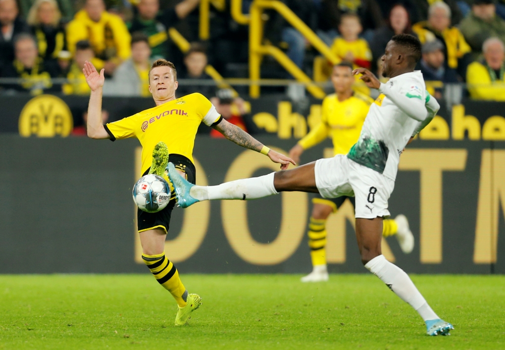 Borussia Dortmund's Marco Reus in action with Borussia Monchengladbach's Denis Zakaria at Signal Iduna Park, Dortmund, Germany, on Saturday. — Reuters