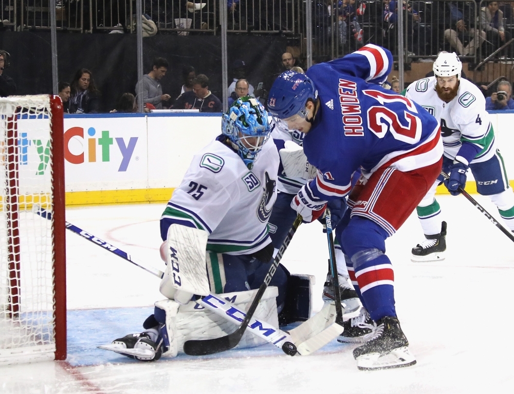 Jacob Markstrom No. 25 of the Vancouver Canucks makes the second period save on Brett Howden No. 21 of the New York Rangers at Madison Square Gardenin New York City, on Sunday. — AFP