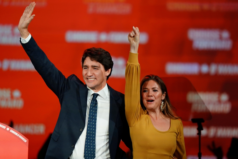 Liberal leader and Canadian Prime Minister Justin Trudeau and his wife Sophie Gregoire Trudeau wave to supporters after the federal election at the Palais des Congres in Montreal, Quebec, Canada, on Tuesday. — Reuters