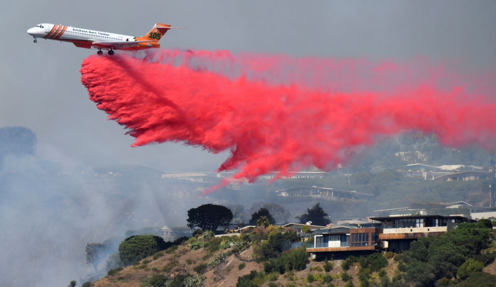 Firefighters battle a blaze from the air that was threatening homes in the Pacific Palisades community of Los Angeles, California, on Monday. — Reuters