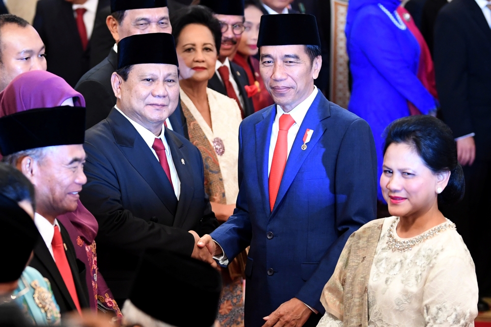 Indonesian Defense Minister Prabowo Subianto is congratulated by Indonesian President Joko Widodo, as First Lady Iriana Widodo stands next to them, after the swearing-in ceremony during the inauguration at the Presidential Palace in Jakarta, Indonesia, on Wednesday. — Reuters