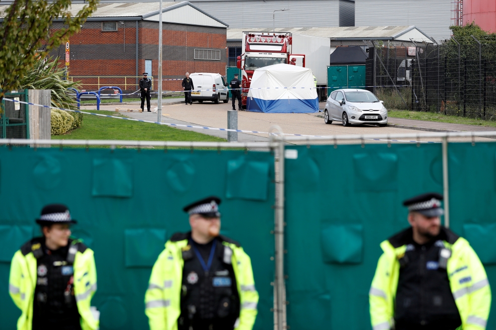 Police is seen at the scene where bodies were discovered in a lorry container, in Grays, Essex, Britain, on Thursday. — Reuters