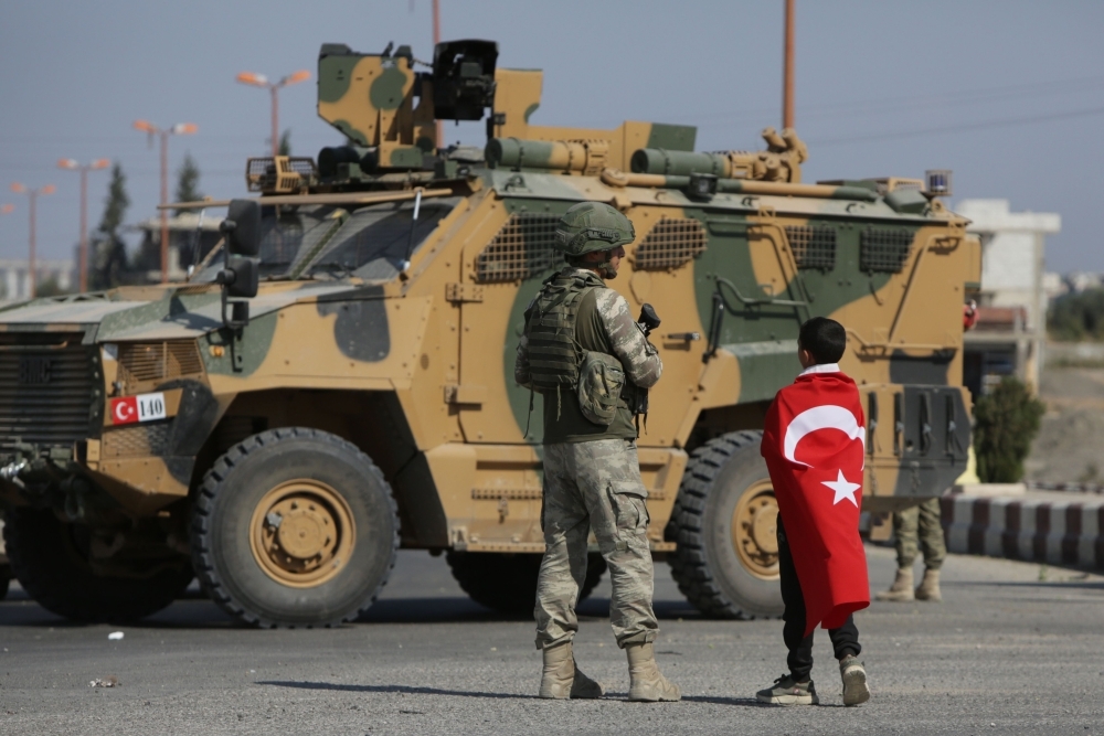 Turkish soldiers patrol the northern Syrian Kurdish town of Tal Abyad, on the border between Syria and Turkey, on Wednesday. — AFP