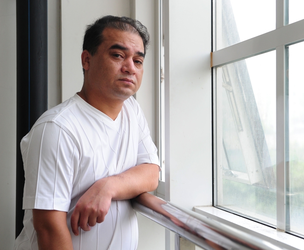 University professor, blogger and member of the Muslim Uighur minority, Ilham Tohti pauses for a few moments for a view from the window before a classroom lecture in Beijing in this June 12, 2010 file photo. — AFP