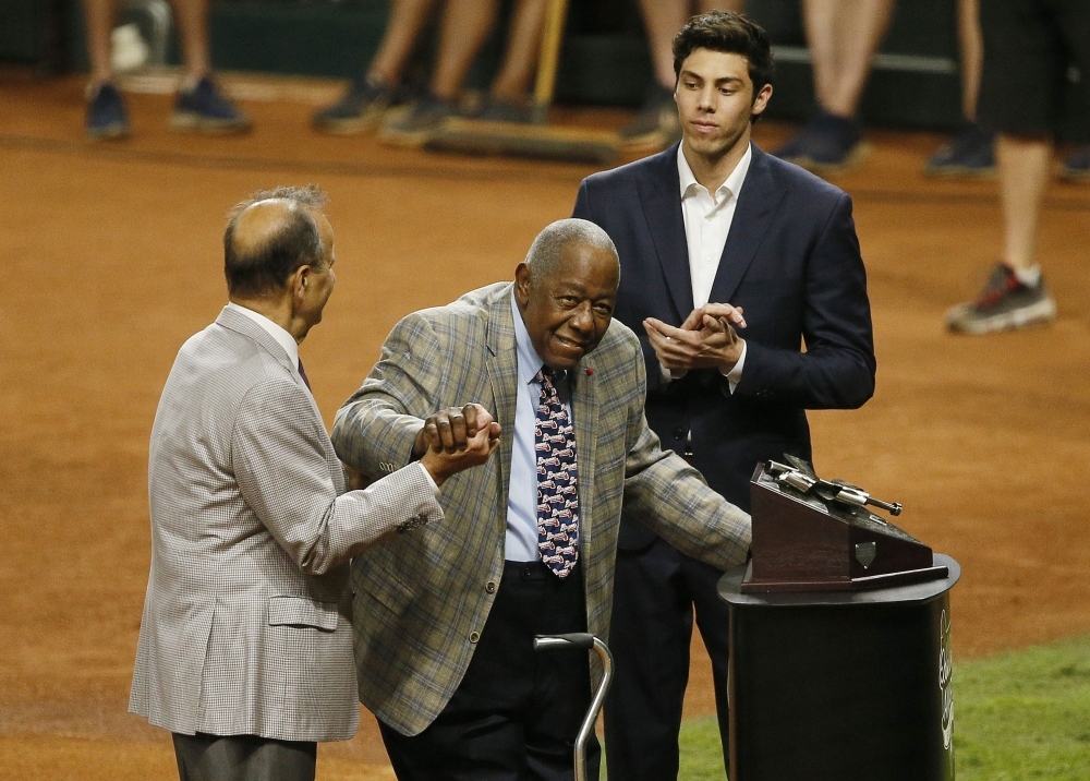 Christian Yelich of the Milwaukee Brewers is presented the Hank Aaron award by Joe Torre and Hank Aaron prior to Game Two of the 2019 World Series between the Houston Astros and the Washington Nationals at Minute Maid Park on Wednesday in Houston, Texas. — AFP