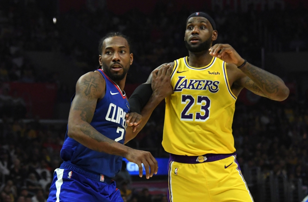 Los Angeles Lakers forward LeBron James (23) is defended by LA Clippers forward Kawhi Leonard (2) in the second half at Staples Center. The Clippers defeated the Lakers 112-102.  — Reuters