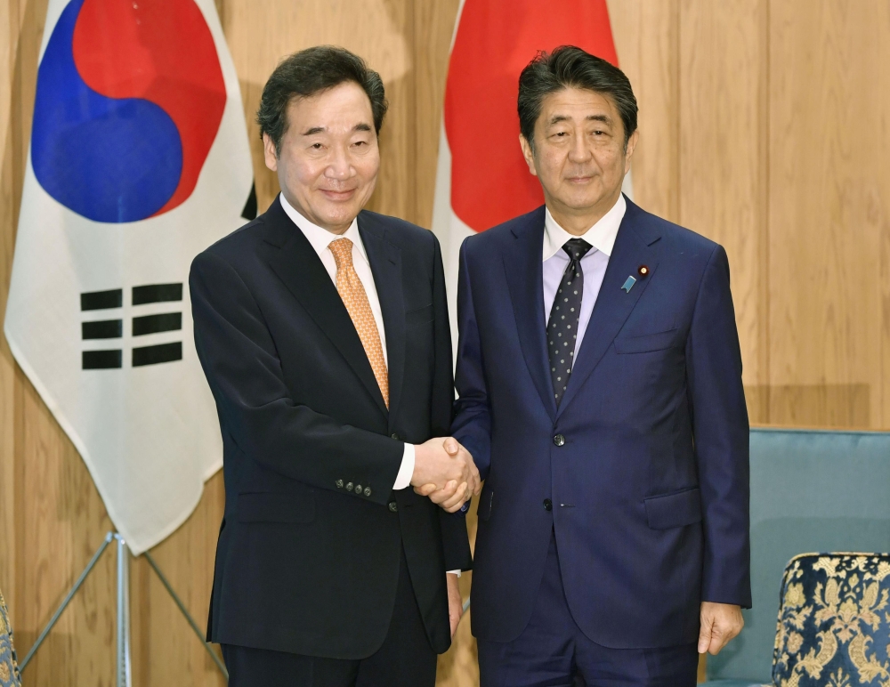 South Korea's Prime Minister Lee Nak-yon, left, meets with Japan's Prime Minister Shinzo Abe at Abe's official residence in Tokyo on Thursday. — Reuters