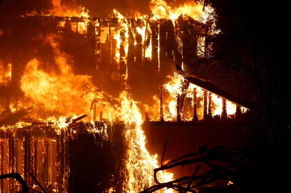 A structure burns during the Kincade fire in Geyserville, California, US, on Thursday. — Reuters