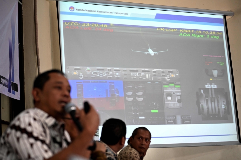 Indonesia's National Transportation Safety Committee (KNKT) investigator Nurcahyo Utomo (L) briefs journalists during a press conference on the final report of the Lion Air flight 610 crash, in Jakarta on Friday. Design flaws in the Boeing 737 Max's flight-control system was a key factor in the crash of a Lion Air jet, which killed 189 people, Indonesian investigators said in their final report on the disaster.  — AFP