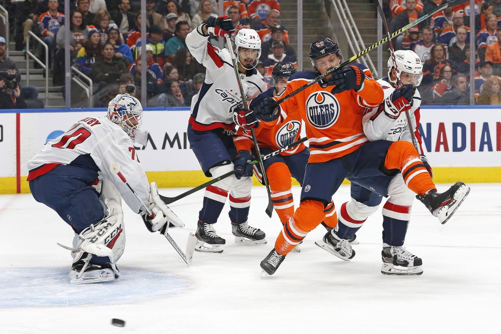 Edmonton Oilers forward Markus Granlund (60) is tripped up by Washington Capitals defensemen Radio Gudas (33) in front of goaltender Braden Holtby (70) during the first period at Rogers Place. — Reuters