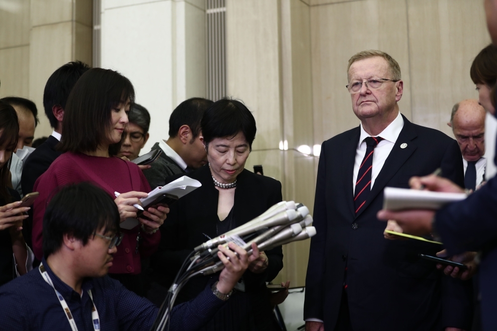 Chairman of the Tokyo 2020 Olympic Games coordination committee, John Coates (R) speaks to the media after meeting with Tokyo Governor Yuriko Koike (not pictured) in Tokyo on Friday. Tokyo's governor said she opposes moving next year's Olympic marathon and race-walking events to northern Japan over heat fears, describing the proposal as a 