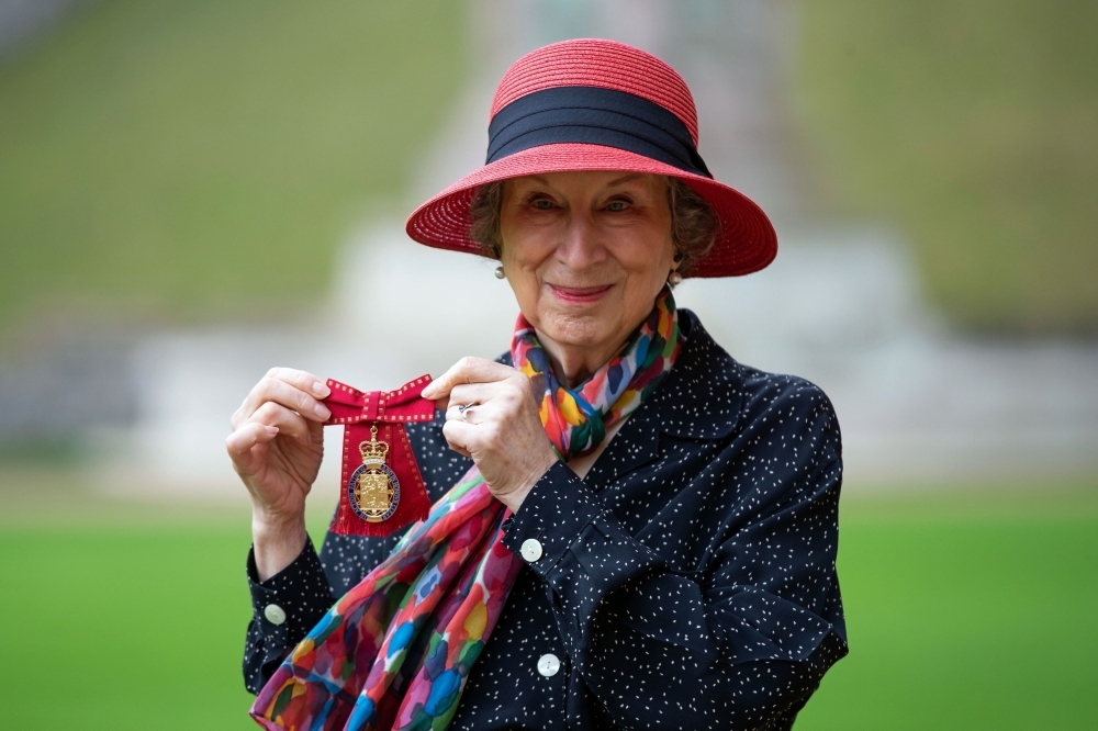 Canadian novelist Margaret Atwood poses with her medal after being made a Member of the Order of the Companions of Honour for services to literature by Britain's Queen Elizabeth II, after an investiture ceremony at Windsor Castle, Windsor, on Friday. — AFP