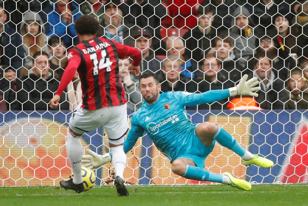 Watford's Ben Foster saves a shot from Bournemouth's Arnaut Groeneveld at Vicarage Road, Watford, Britain, on Saturday. — Reuters
