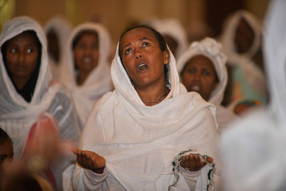 Christian Orthodox faithful pray at a church in Addis Ababa, during the memorial service for the victims of the violence which erupted earlier in the month in the Oromia region and at the outskirts of the capital. — AFP
