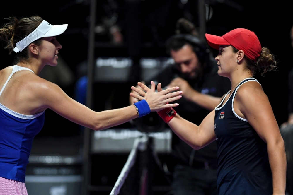 Australia's Ashleigh Barty (R) greets Belinda Bencic of Switzerland after winning their women's singles first round match in the WTA Finals tennis tournament in Shenzhen, on Sunday. — AFP