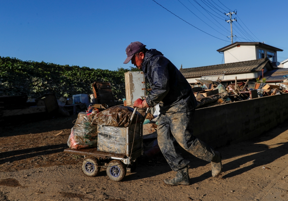 A man cleans debris in the aftermath of Typhoon Hagibis in Yanagawamachi district, Date City, Fukushima prefecture, Japan, in this Oct. 16, 2019 file photo. — Reuters