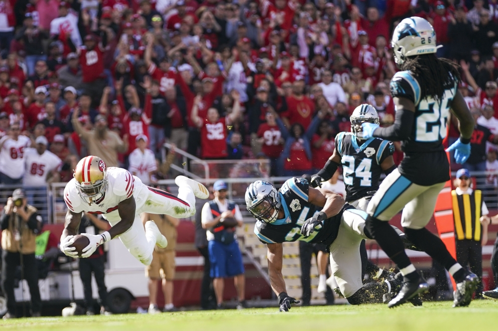 San Francisco 49ers running back Tevin Coleman (26) scores a touchdown against Carolina Panthers strong safety Eric Reid (25) during the first quarter at Levi's Stadium, Santa Clara, CA, USA, on Sunday. — Reuters