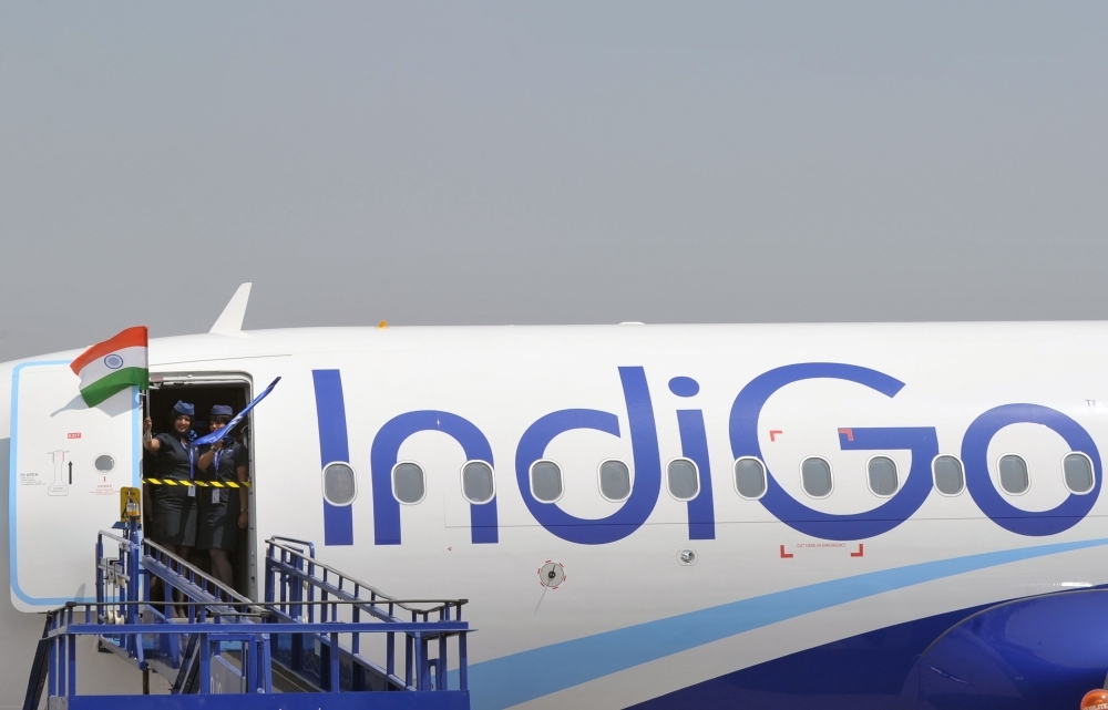 Crew members of an IndiGo Airbus A320 aircraft wave an Indian national flag at The India Aviation 2016 airshow at Begumpet Airport in Hyderabad in this March 16, 2016 file photo. — AFP