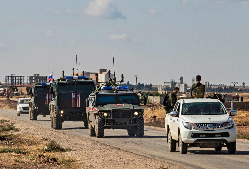 Syrian Kurdish Asayish internal security forces and Russian military police patrol the town of Darbasiyah in Syria's northeastern Hasakeh province along the Syria-Turkey border on Wednesday. — AFP