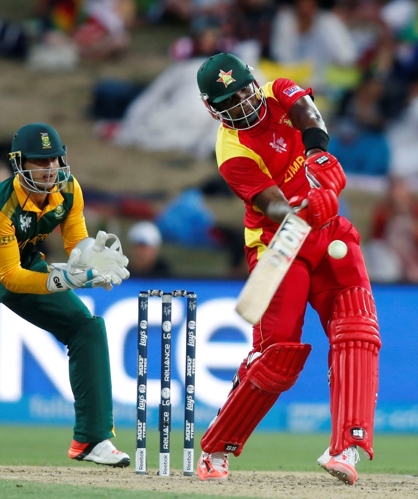 In this file photo taken on Feb. 15, 2015, Zimbabwe's batsman Hamilton Masakadza (R) plays a shot watched by South Africa's Quentin De Kock during their Cricket World Cup match in Hamilton. — Reuters