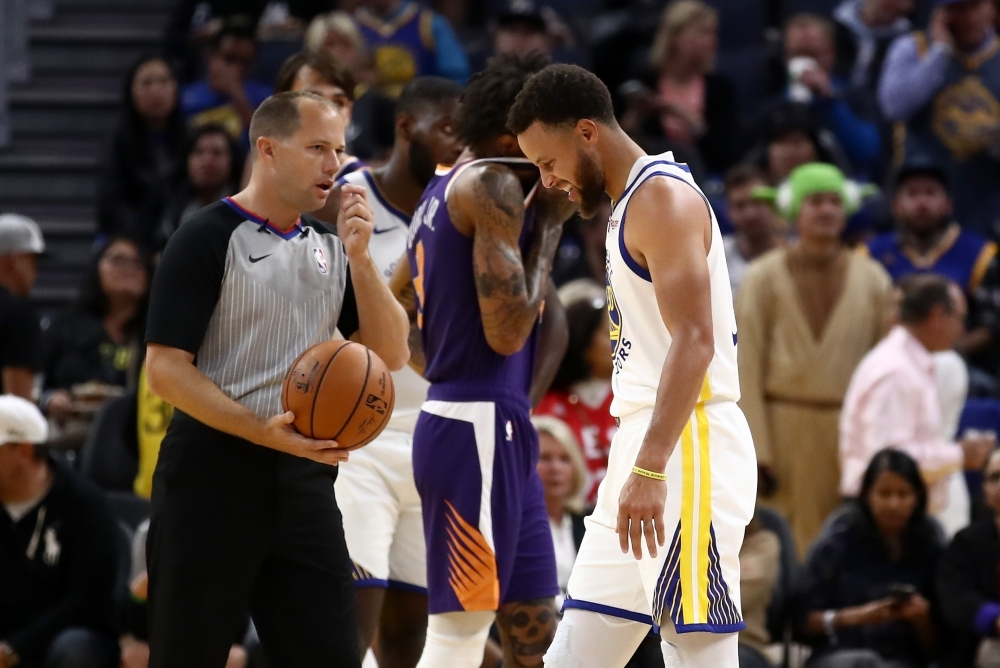 Stephen Curry #30 of the Golden State Warriors grimaces after he was injured in the second half of their game against the Phoenix Suns at Chase Center in San Francisco, California, on Wednesday. — AFP