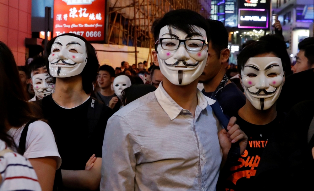 Anti-government protesters wearing costumes march during Halloween in Lan Kwai Fong, Central district, Hong Kong, China, on Thursday. — Reuters