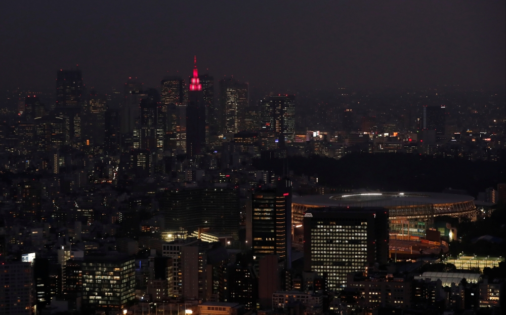 A general view of the NTT DoCoMo Yoyogi Building, and  New National Stadium, centre piece of the 2020 Tokyo Olympics and Paralympics, Tokyo, Japan, on Thursday.  — Reuters